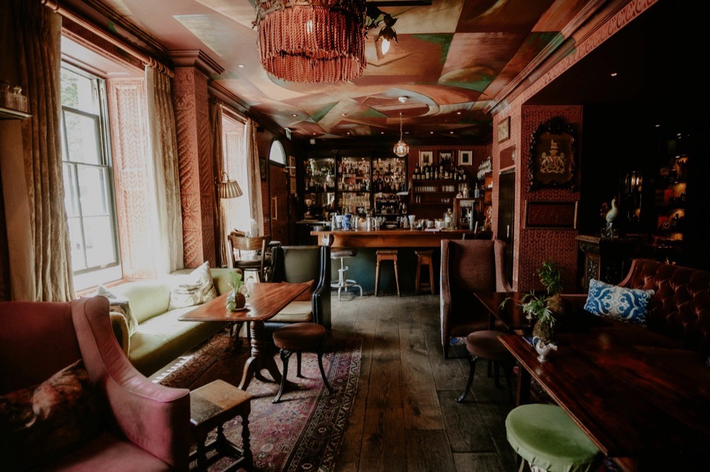 The bar at The Zetter Clerkenwell, low seating and a painted ceiling