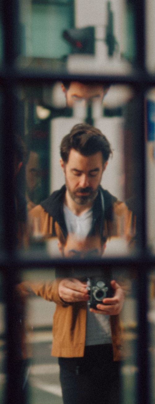 Shane Taylor photographing on a street